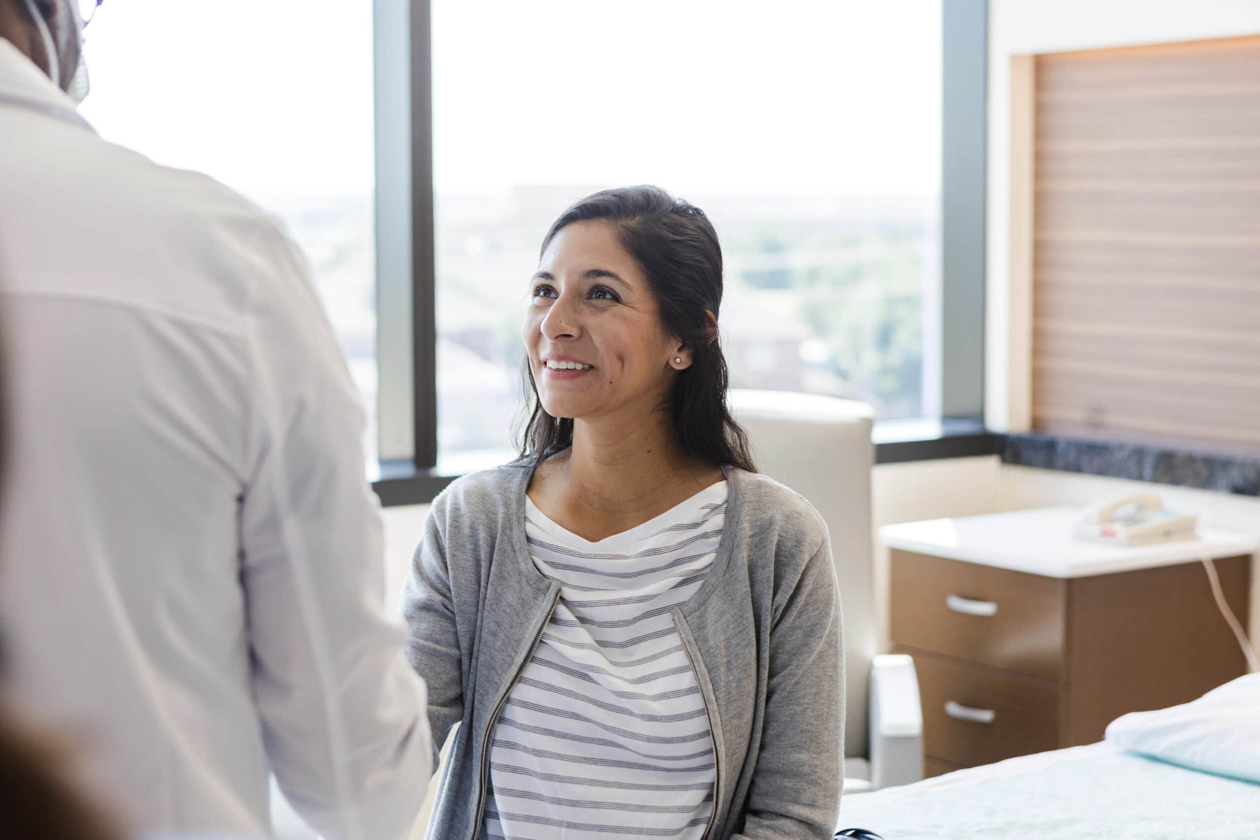 Mid Adult Woman in Doctor's Office Receiving Healthcare