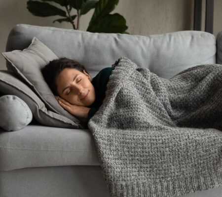 A woman taking a nap on a couch