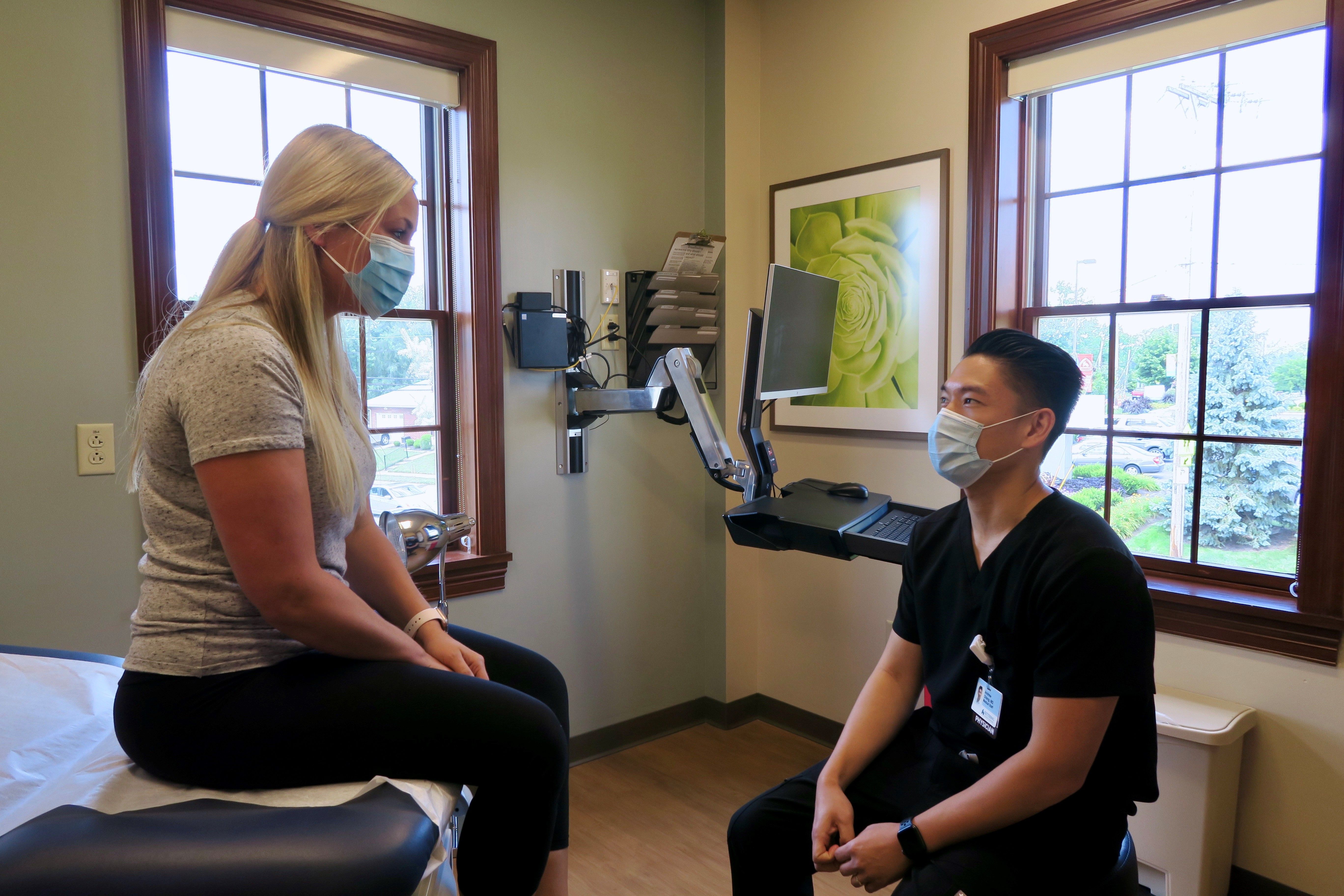 Dr. Andrew Chang talks with a patient