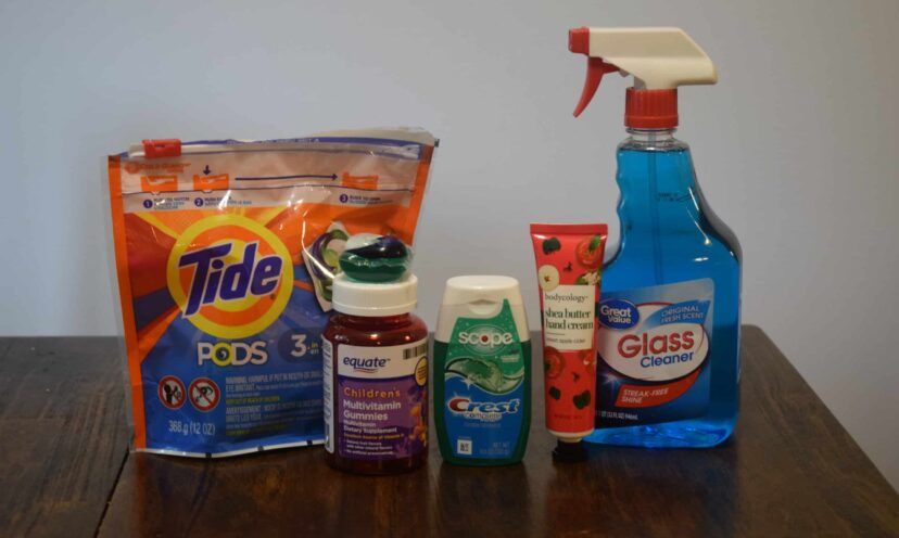 Tide pods, gummy vitamins, toothpaste, lotion, and window cleaning liquid in a row