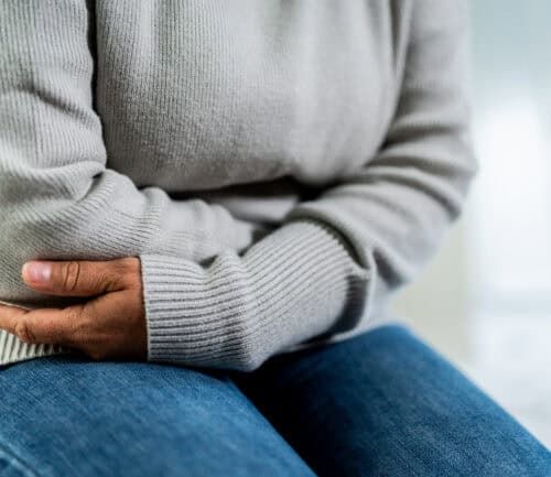 Woman holding her stomach in pain