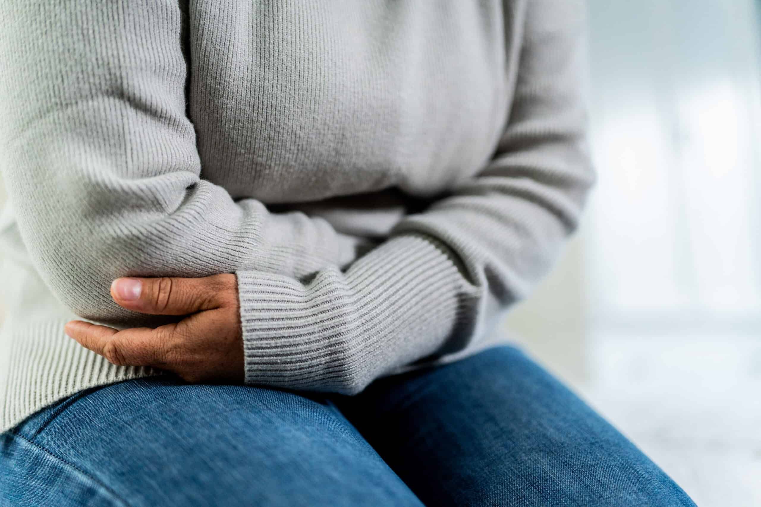 Woman holding her stomach in pain