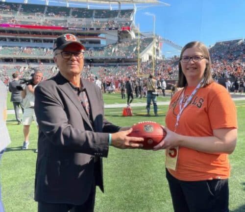 Kelly Long receiving game ball at Bengals game