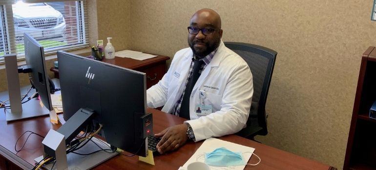 Dr. Udom at desk