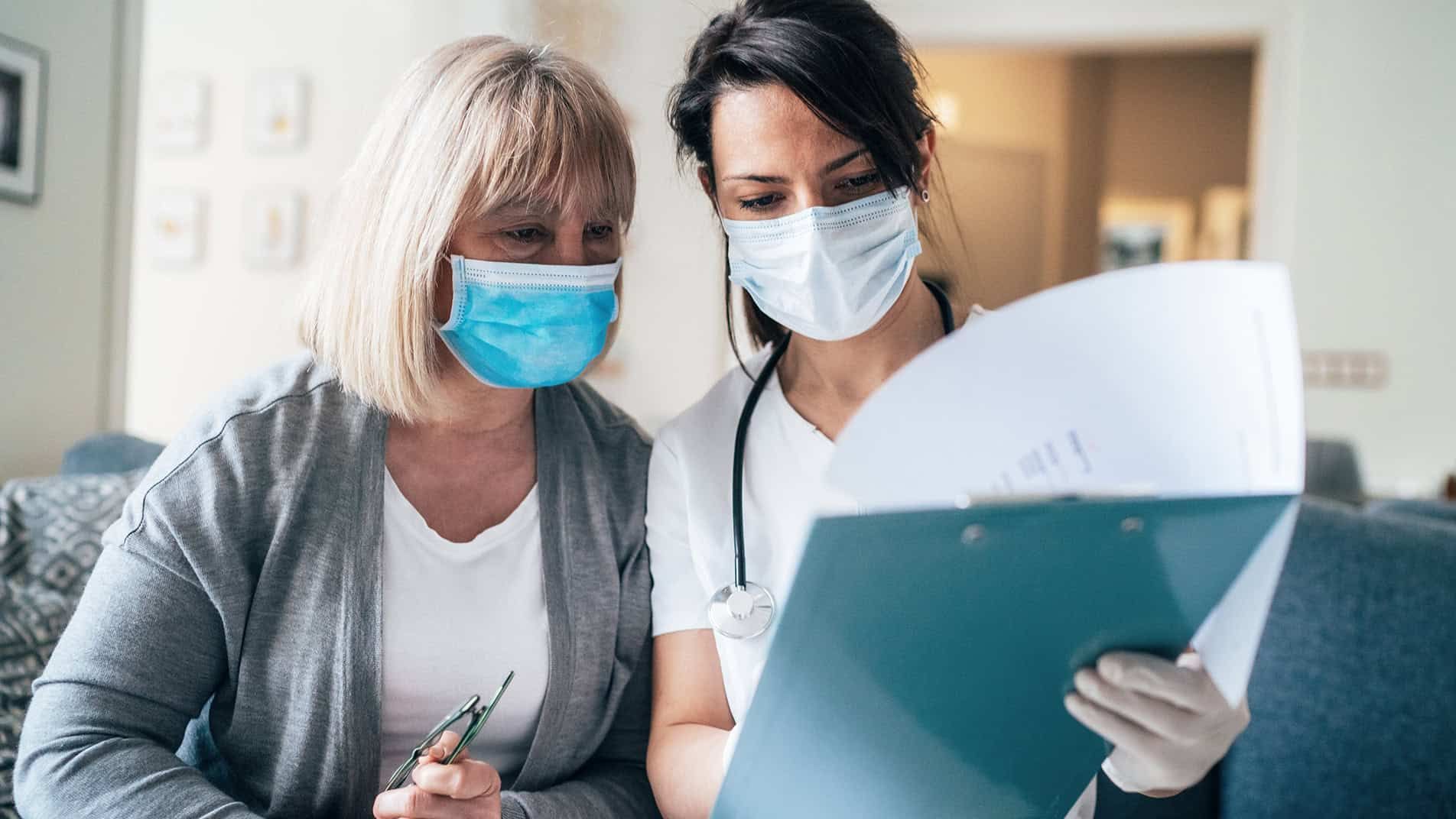 Nurse and patient reviewing chart information – Kettering Health