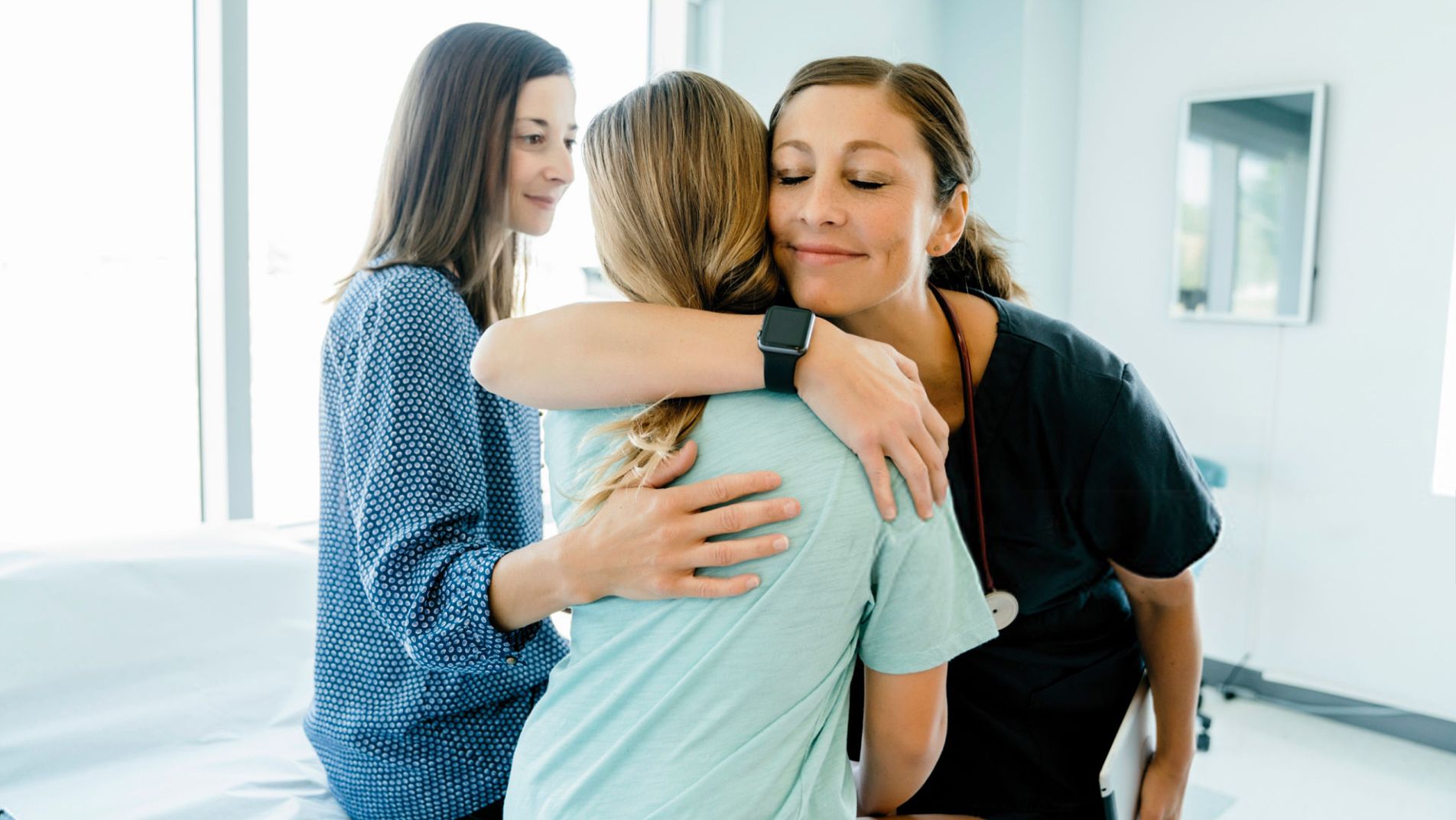 patient receiving a hug from a nurse