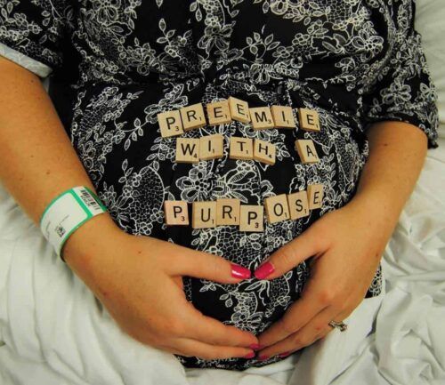 Bethanie Shepherd's pregnant belly with scrabble letters spelling out "premie with a purpose"