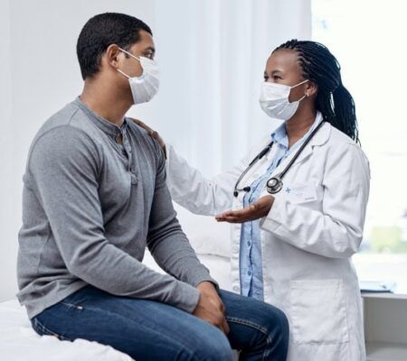doctor talks with patient during appointment