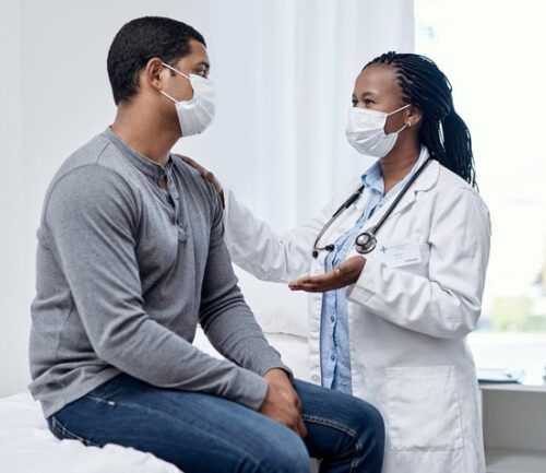 doctor talks with patient during appointment