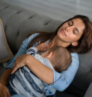 exhausted mother holding baby