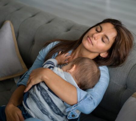 exhausted mother holding baby