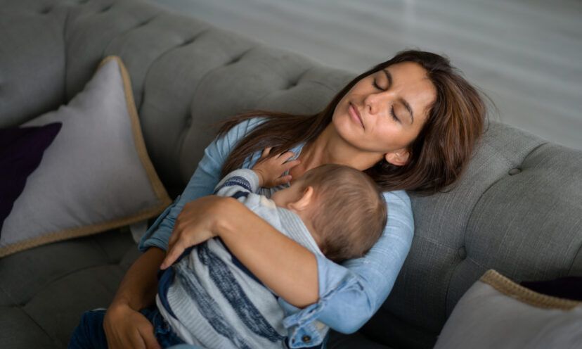 exhausted mother holding baby