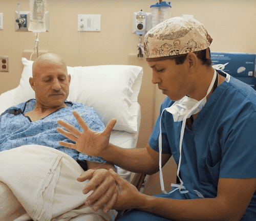 Resident consults with patient before free hand surgery