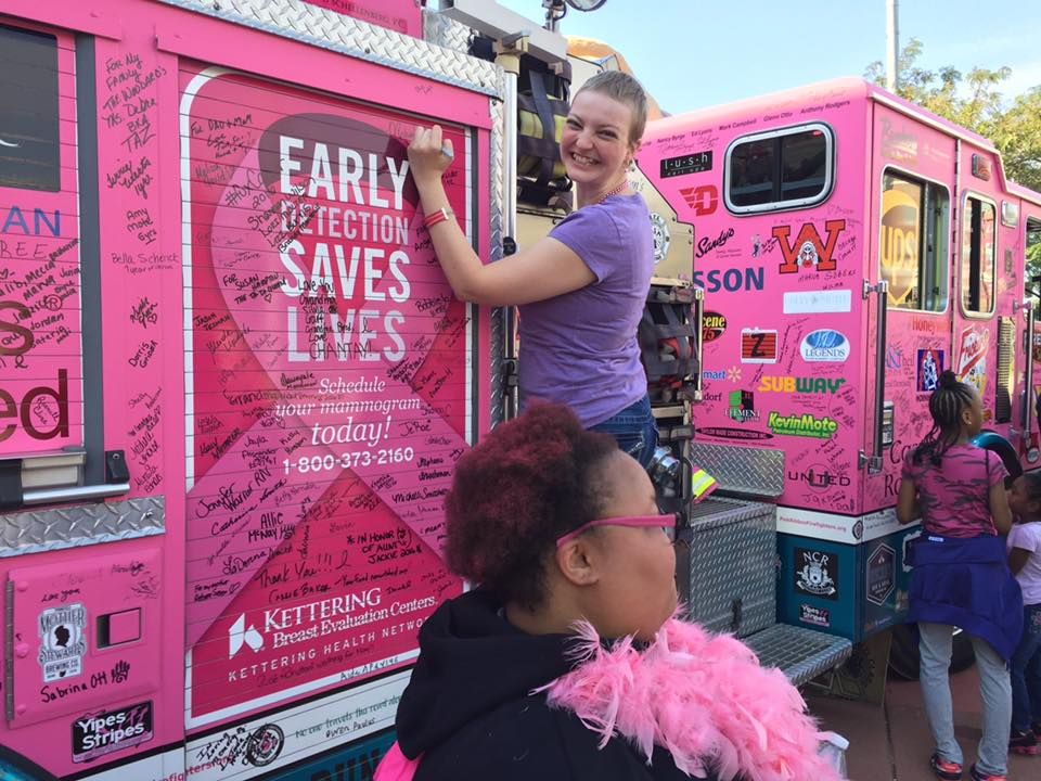 Melissa Lewis signs the pink truck at Making Strides