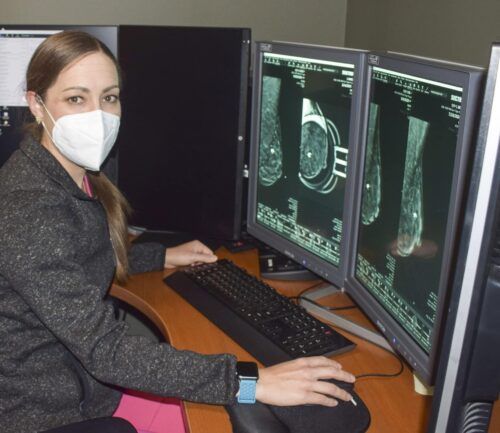 Dr. Musser sits at computer reviewing scan