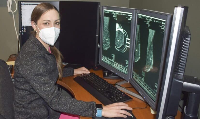 Dr. Musser sits at computer reviewing scan