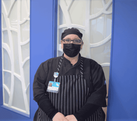 Jade Nohacs stands in front of wall at Kettering Health Miamisburg