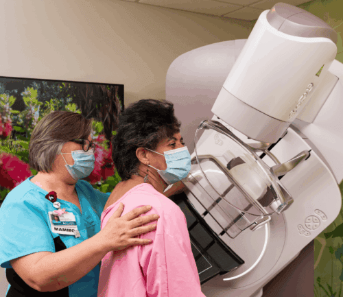 Vernese Butler receives mammogram as tech helps her