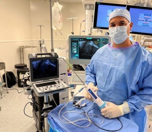 Doctor holds Aquablation Therapy device for prostate health