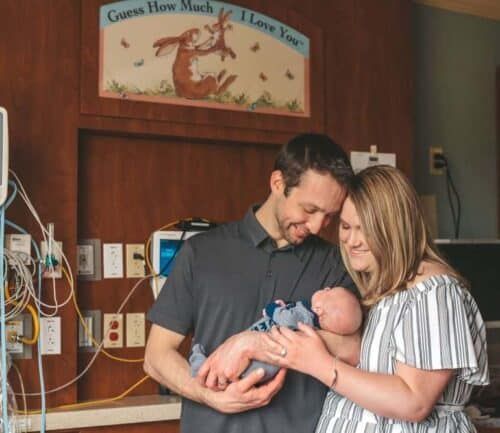 Mother and father holding baby