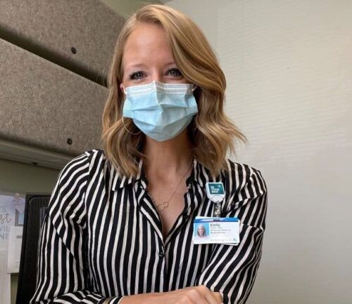 Doctor wearing mask smiles into camera