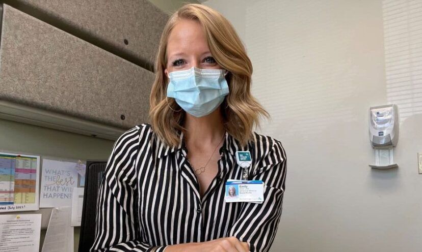 Doctor wearing mask smiles into camera