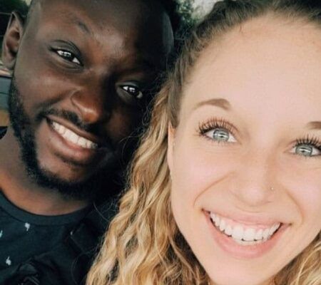 Gabby Wacker and her boyfriend smile into the camera