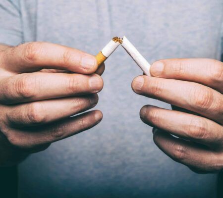 Man crushing cigarette to quit smoking