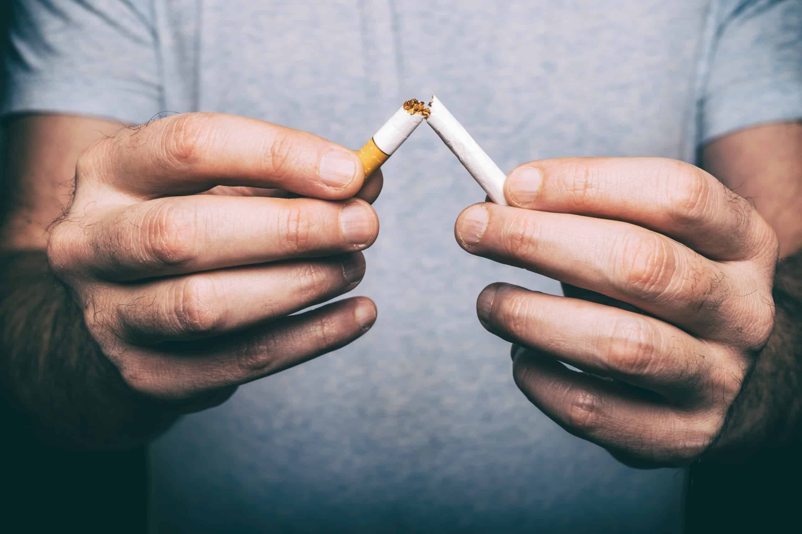 Man crushing cigarette to quit smoking