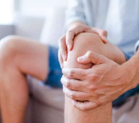 joint health: person holds knee in pain