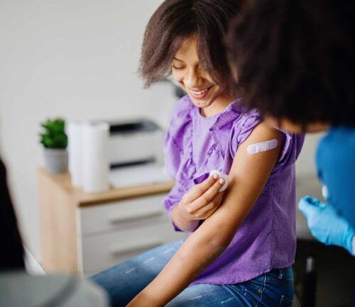 Teen girl receives HPV vaccine