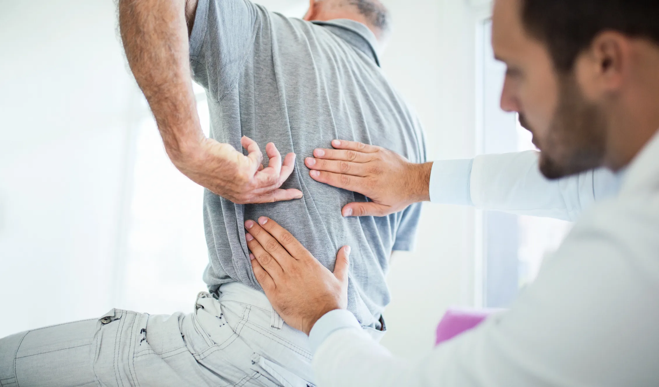 Provider examines patient's back