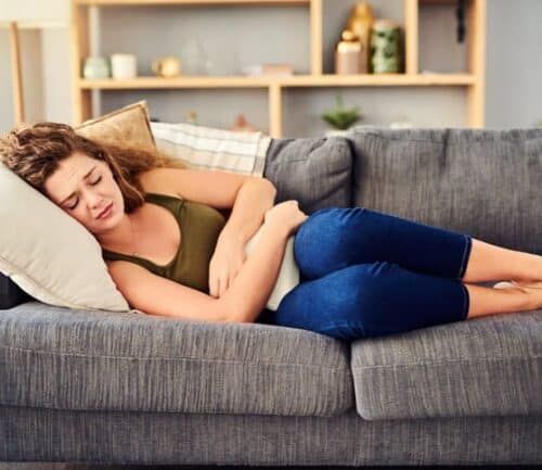 Woman on couch with period pains