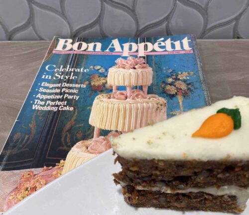 A slice of carrot cake on top of a magazine