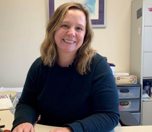 Heather Brown Registered Dietitian smiling at the camera in her office