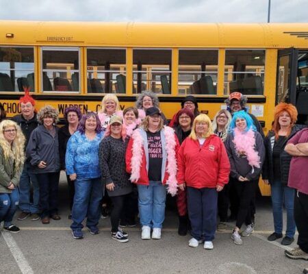 Gail Harvery and friends in front of school bus