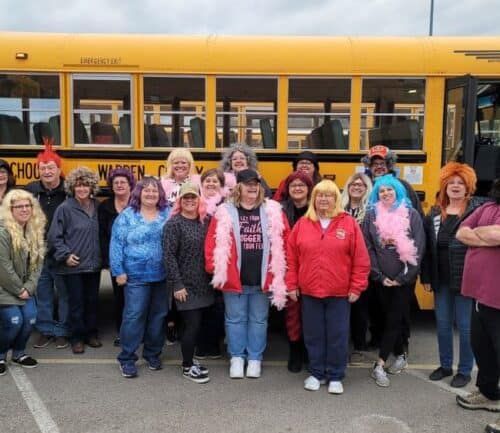 Gail Harvery and friends in front of school bus