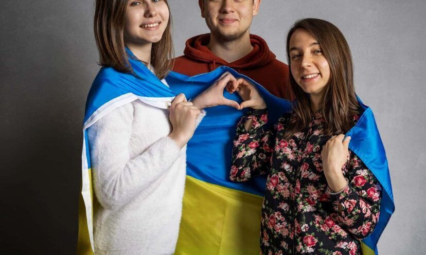 Ukrainian students drape their flag over their shoulders