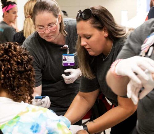 ER nurse checks woman's vitals