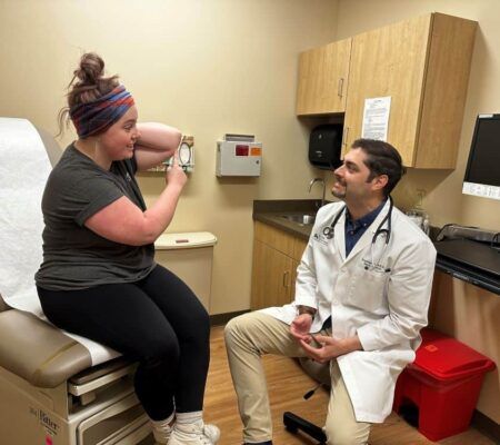 Dr. Jonathan Gaskill explaining wound care to patient