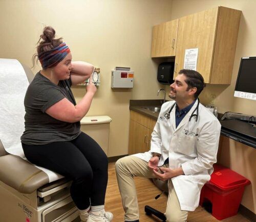 Dr. Jonathan Gaskill explaining wound care to patient