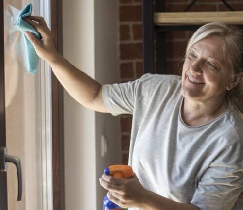 Woman spring cleaning her window