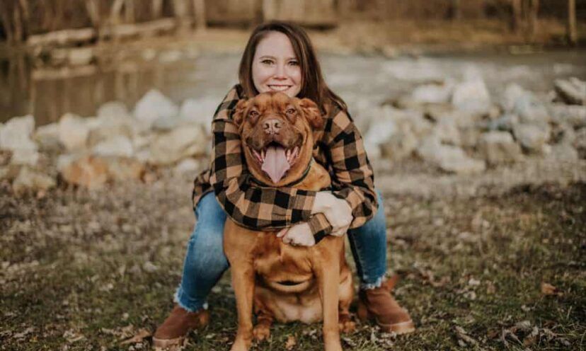 Virginia Chappius hugging her dog outside