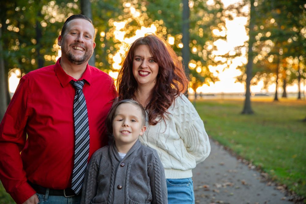 Sarah Peterson, her son, and her husband standing at a park