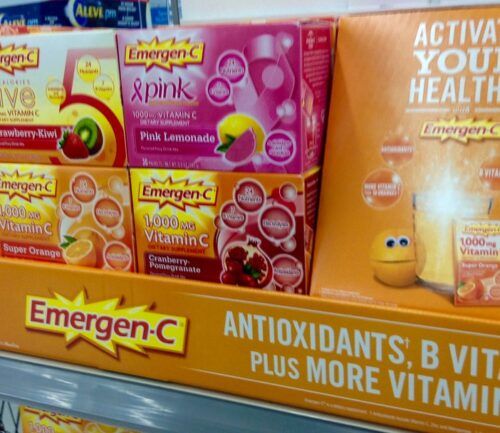 Vitamins and supplements, including Emergen-C, displayed on a drugstore shelf.