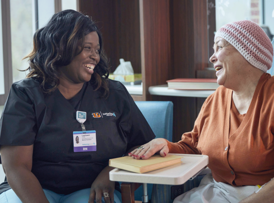 Nurse talking with female cancer patient