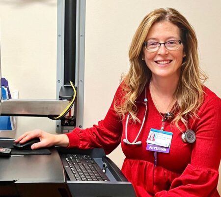 Dr. Deanna Allgeyer smiling at her desk