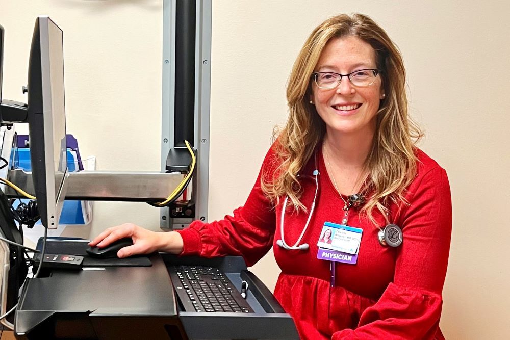 Dr. Deanna Allgeyer smiling at her desk