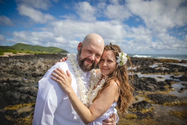 Sarah and her husband Tim pose during their wedding.
