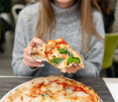 Woman eating meatless pizza